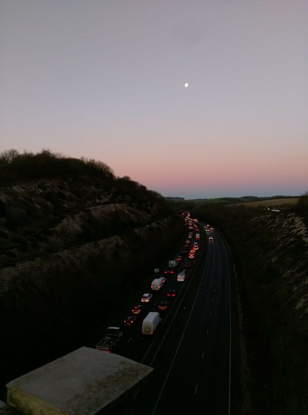 A long queue of cars on a dual carriageway.