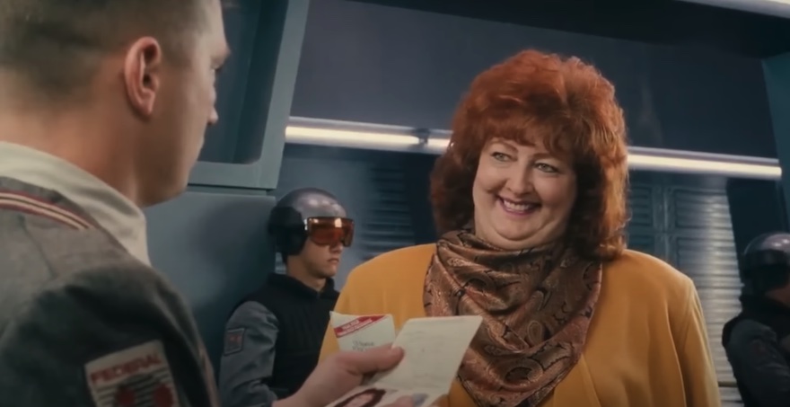 A woman smiling a border control taken from the film Total Recall